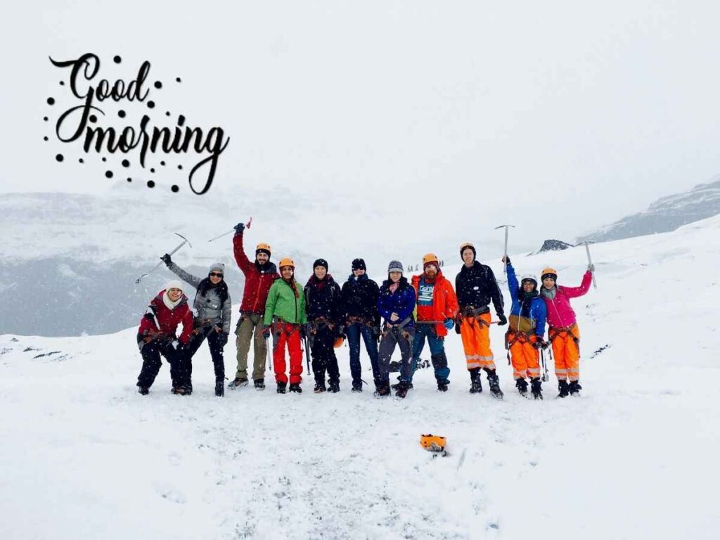 A group of people standing in the snow on a saturday morning, with the words "good morning" written.